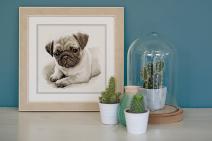 Cross stitched portrait of a pug dog