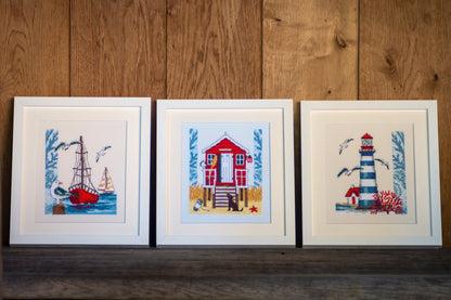 Cross stitch of a lighthouse on ecru fabric