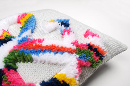 Latch hook cushion with a bright ampersand design