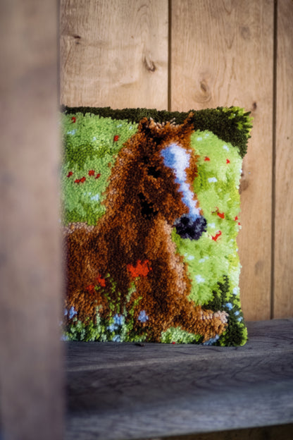 Latch hook cushion with a young foal