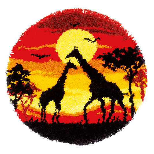 Shaped latch hook rug with giraffes against a sunset