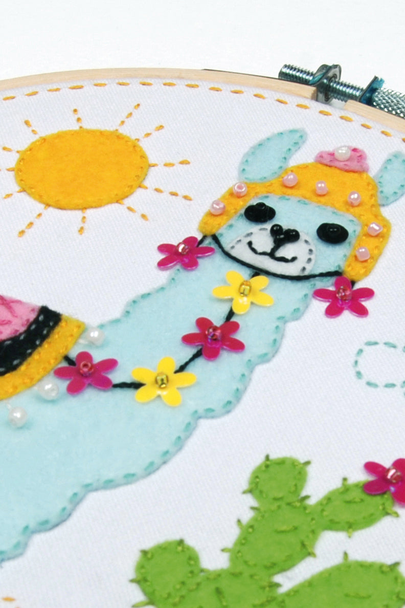 Felt llama picture in a round hoop frame