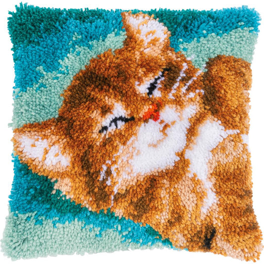 Latch hook cushion showing a purring cat design