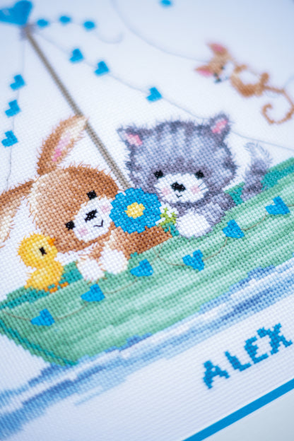 Cross stitched birth record reading Our Greatest Adventure