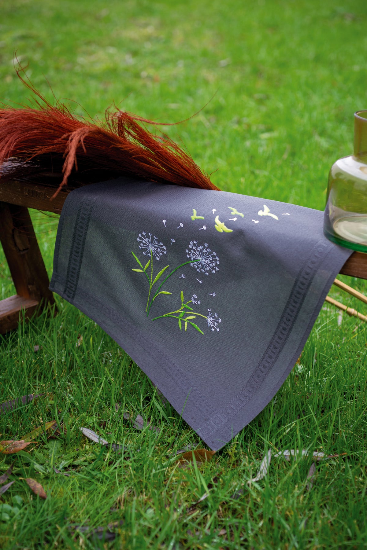 Grey table runner embroidered with Flower Fluff design