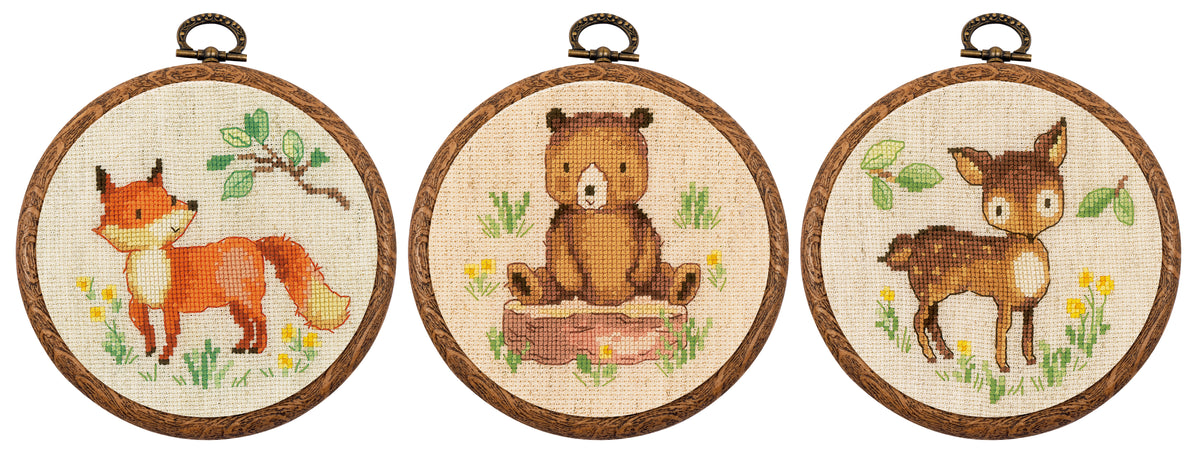 Three small cross stitch forest animal designs in round hoops