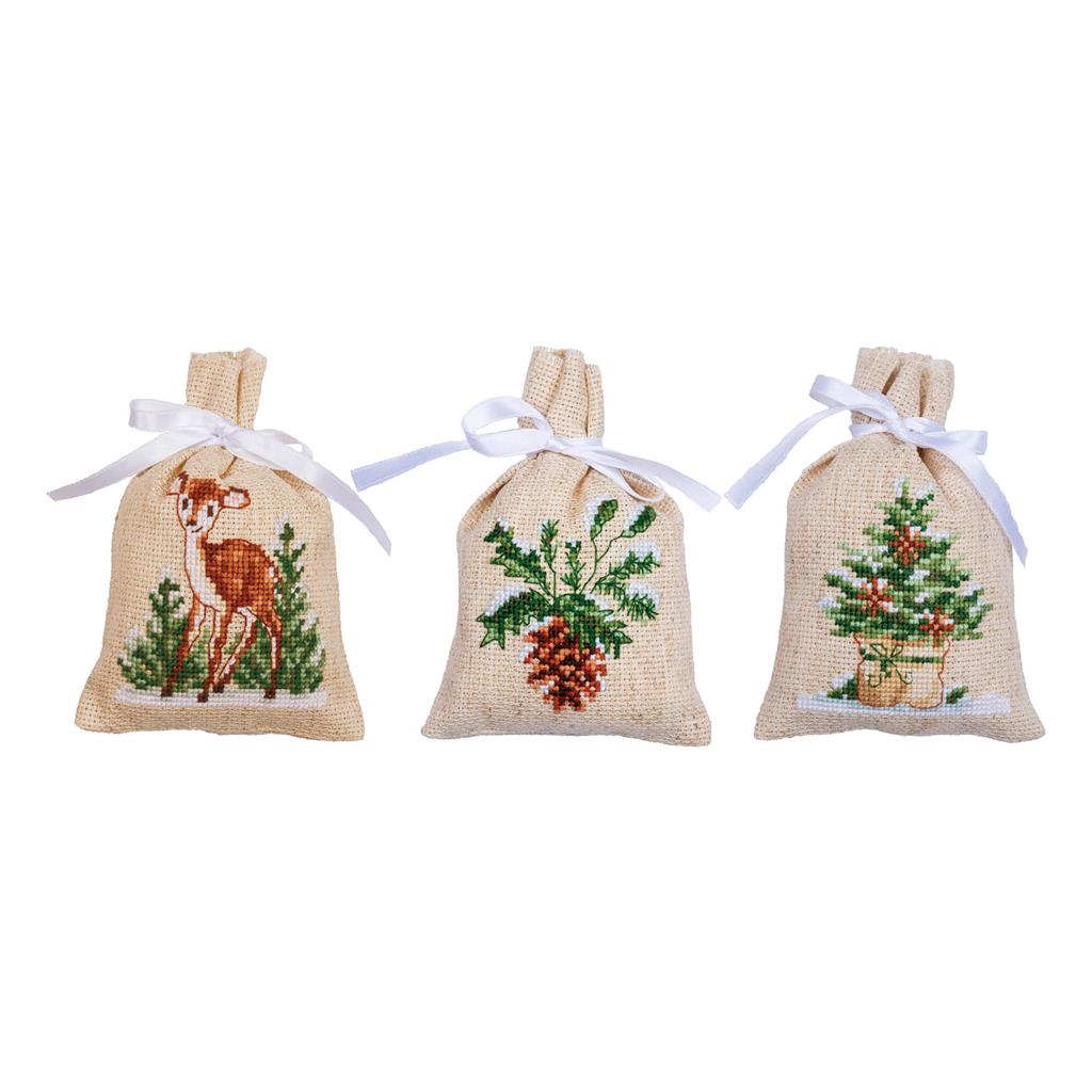 Three small ecru bags cross stitched with winter designs