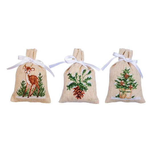 Three small ecru bags cross stitched with winter designs