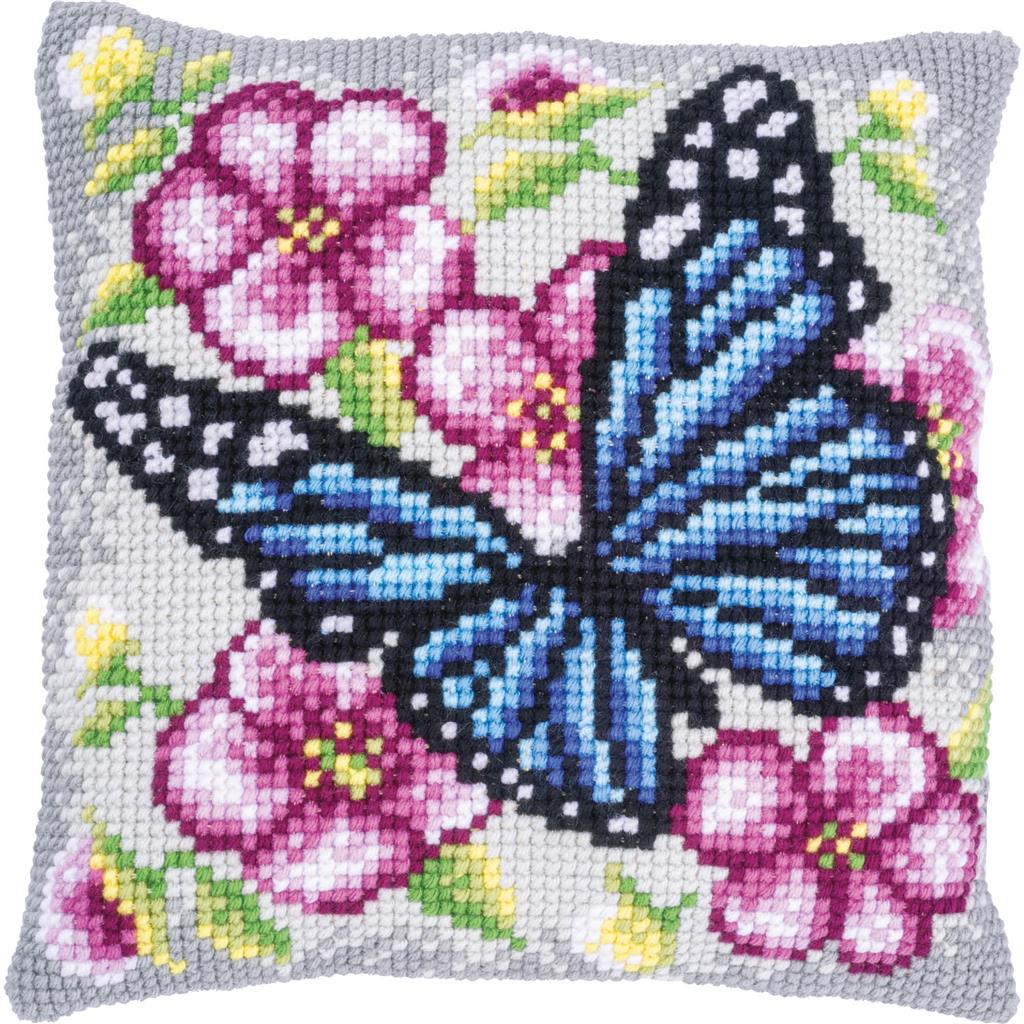Square cushion stitched with a butterfly among flowers
