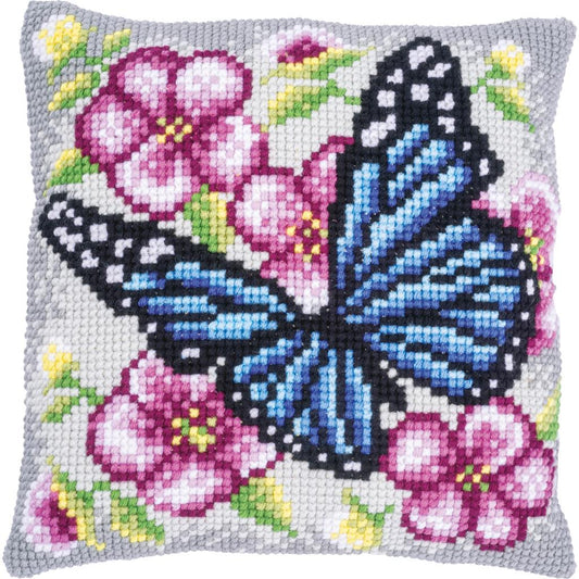 Square cushion stitched with a butterfly among flowers