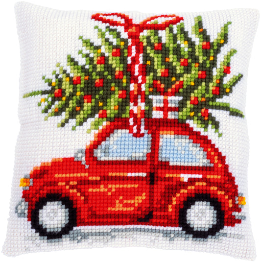 Square cushion stitched with a car carrying a Christmas tree