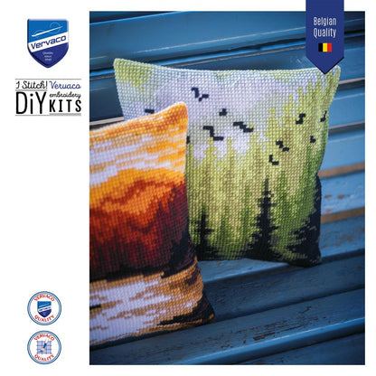 Cross stitch cushion with a mountain landscape design