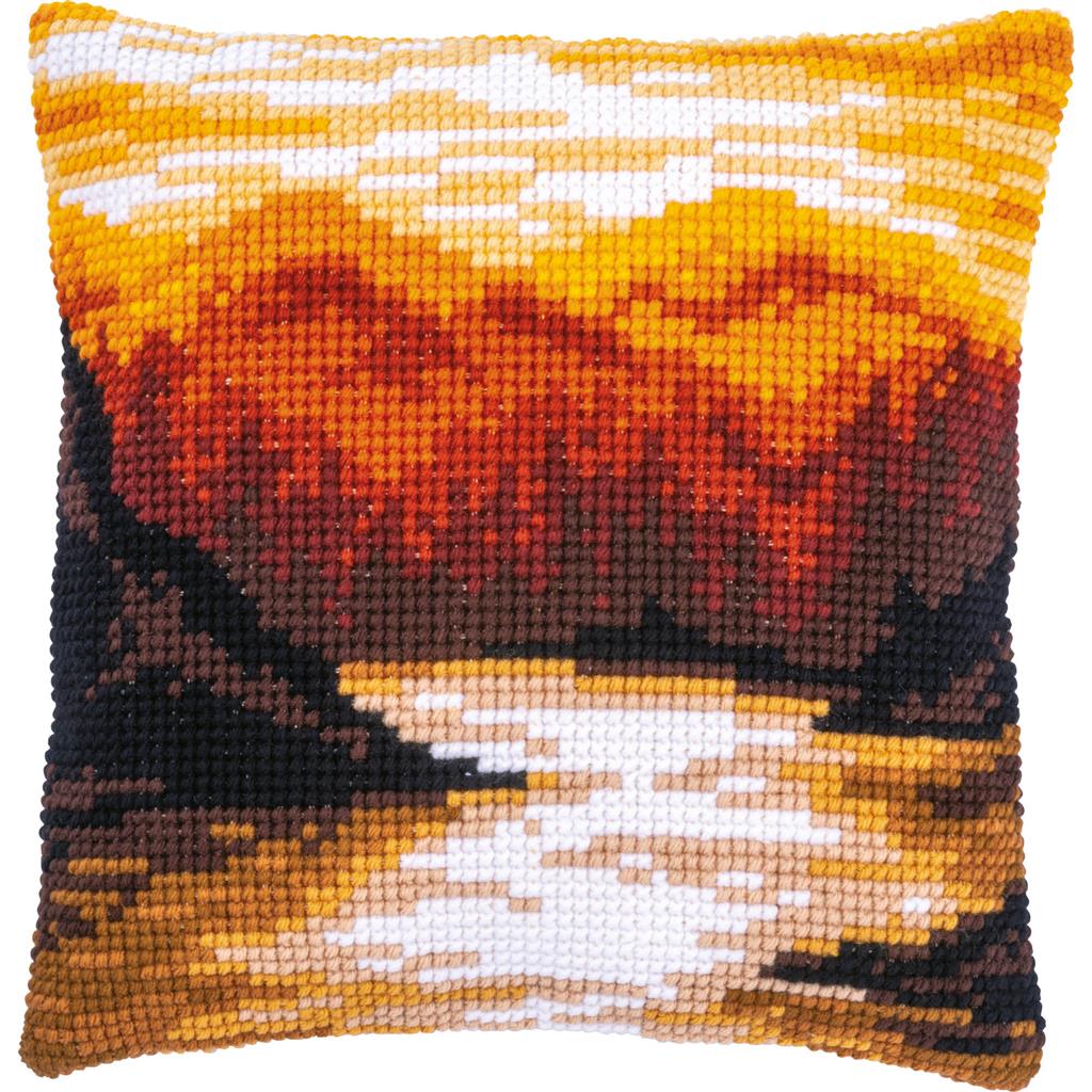 Cross stitch cushion with a mountain landscape design
