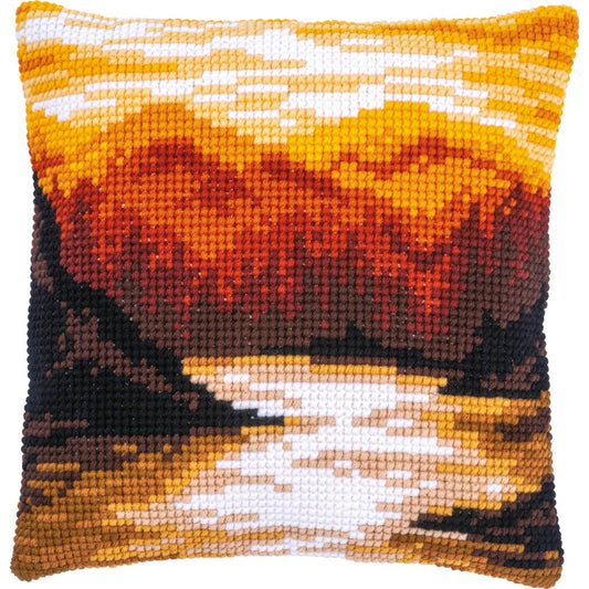 Cross stitch cushion with a mountain landscape design