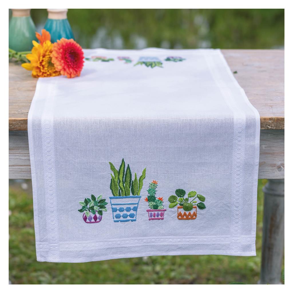 Embroidered table runner with house plants design