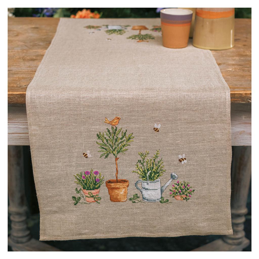 Linen table runner with cross stitched garden tools