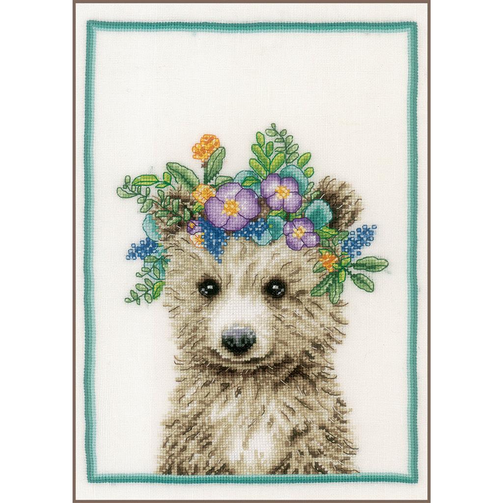 Cross stitch picture of a bear wearing a flower crown