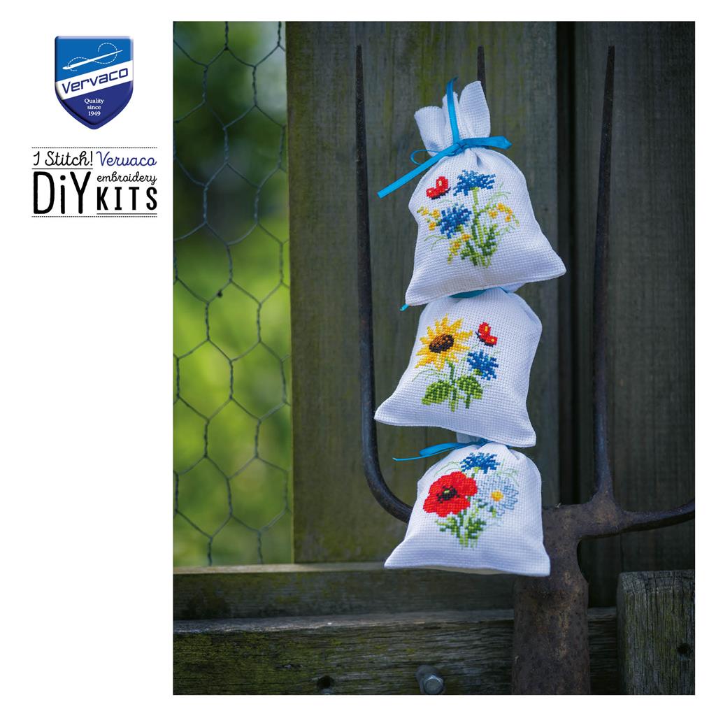 Three small cross stitch bags with field flowers designs