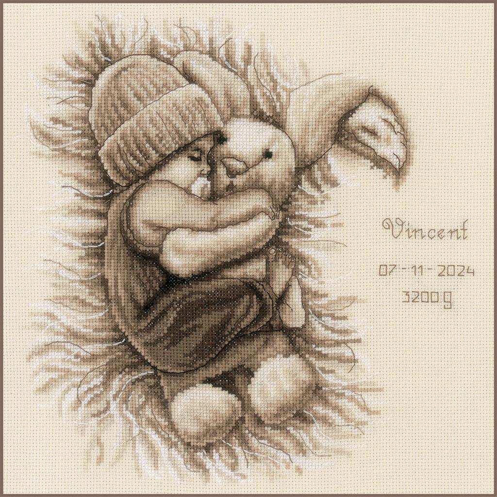 Cross stitch of a baby with a cuddly bunny
