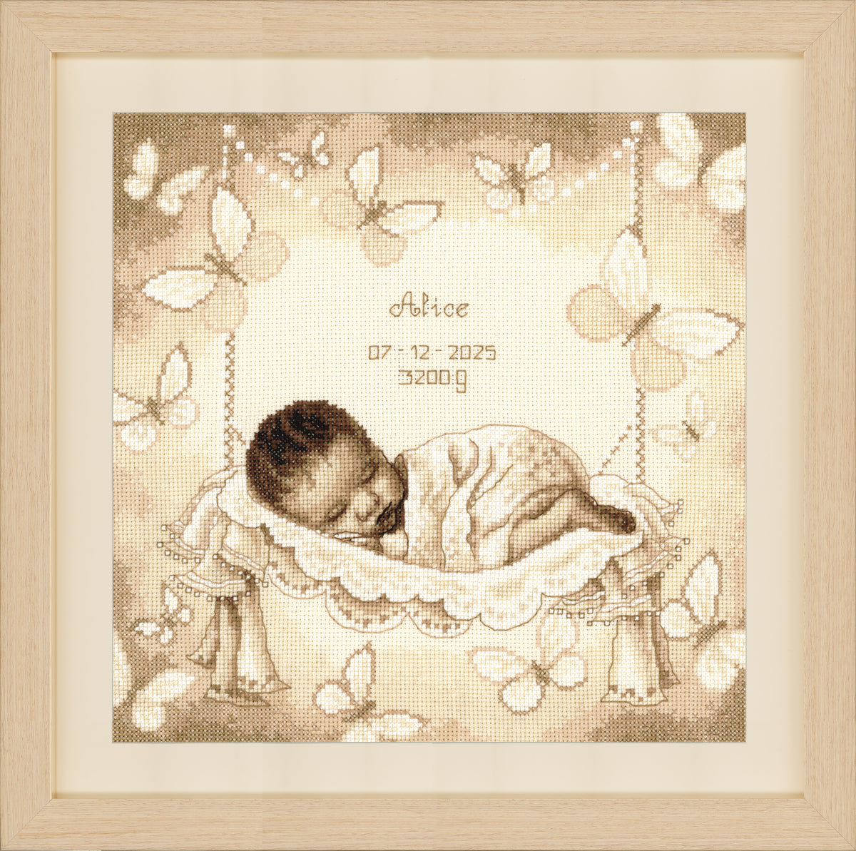 Cross stitch birth record of a baby in a hammock