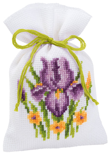 Three small white gift bags cross stitched with flowers