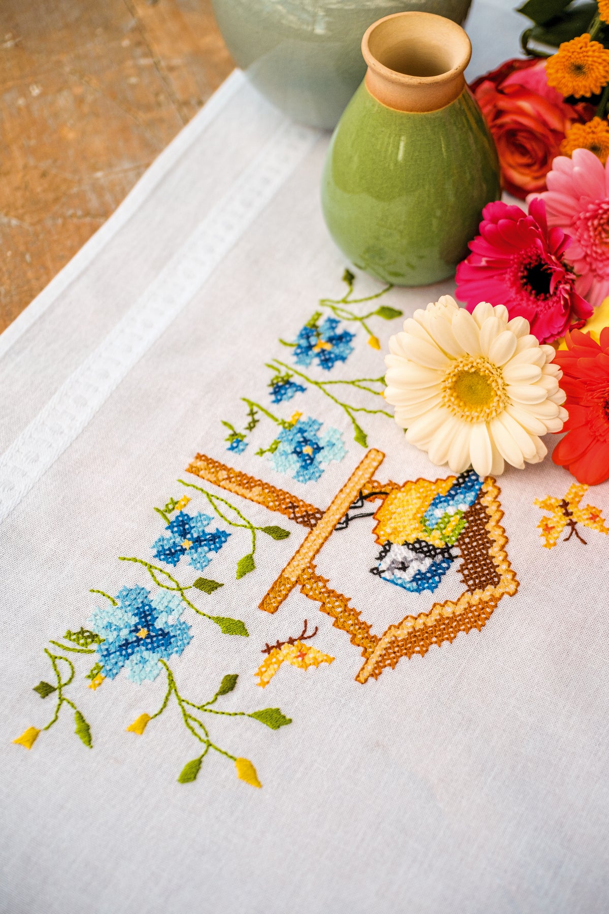 Embroidered tablecloth with birdhouses design
