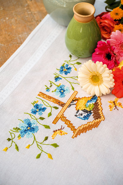 Embroidered tablecloth with birdhouses design