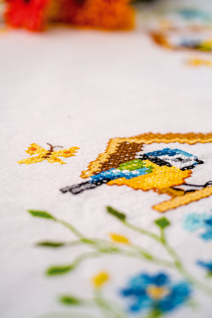 Embroidered tablecloth with birdhouses design