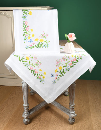 White tablecloth embroidered with colourful field flowers