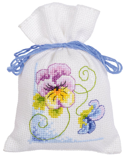 Three violet cross stitch gift bags tied with ribbon