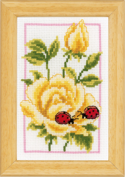 Three small cross stitched designs of flowers and ladybirds