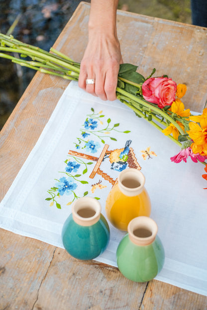 Embroidered table runner with birdhouses design