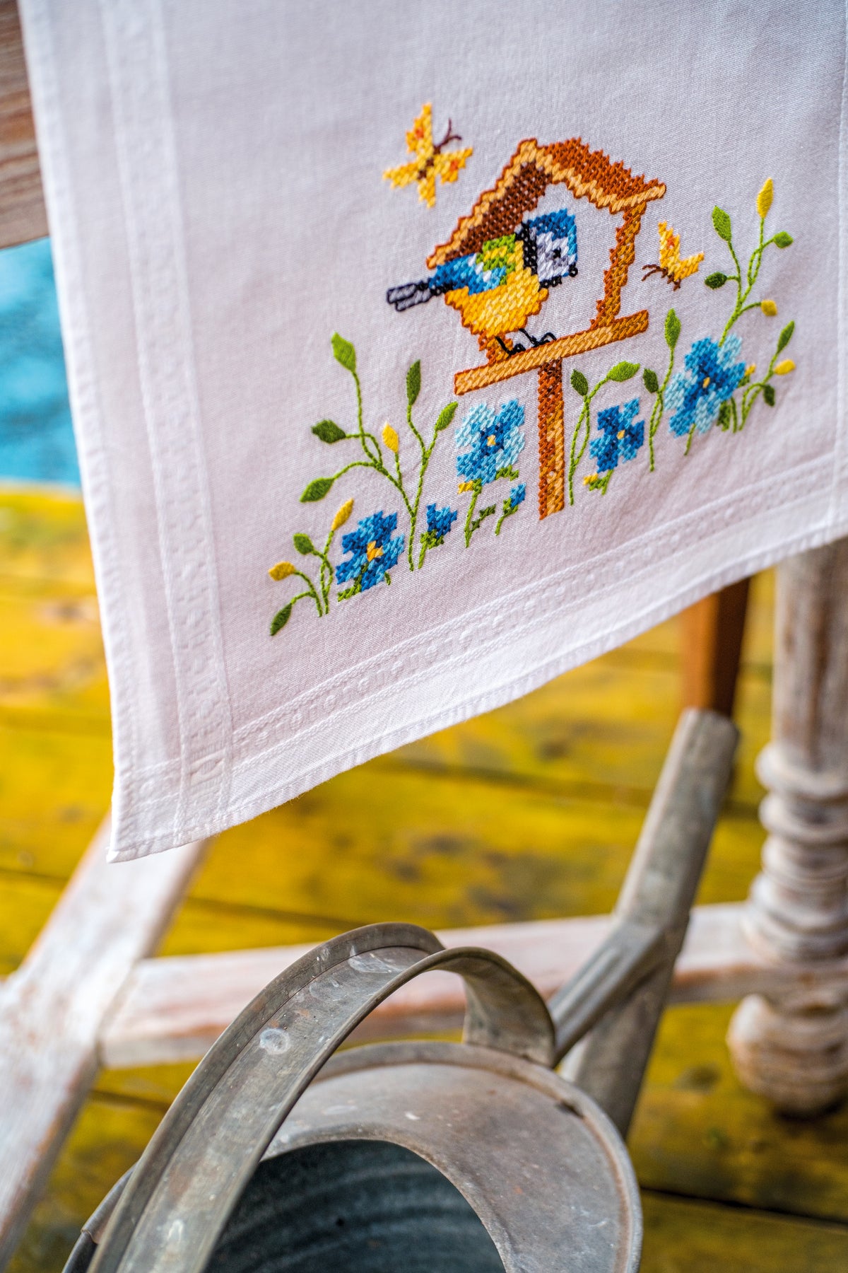 Embroidered table runner with birdhouses design