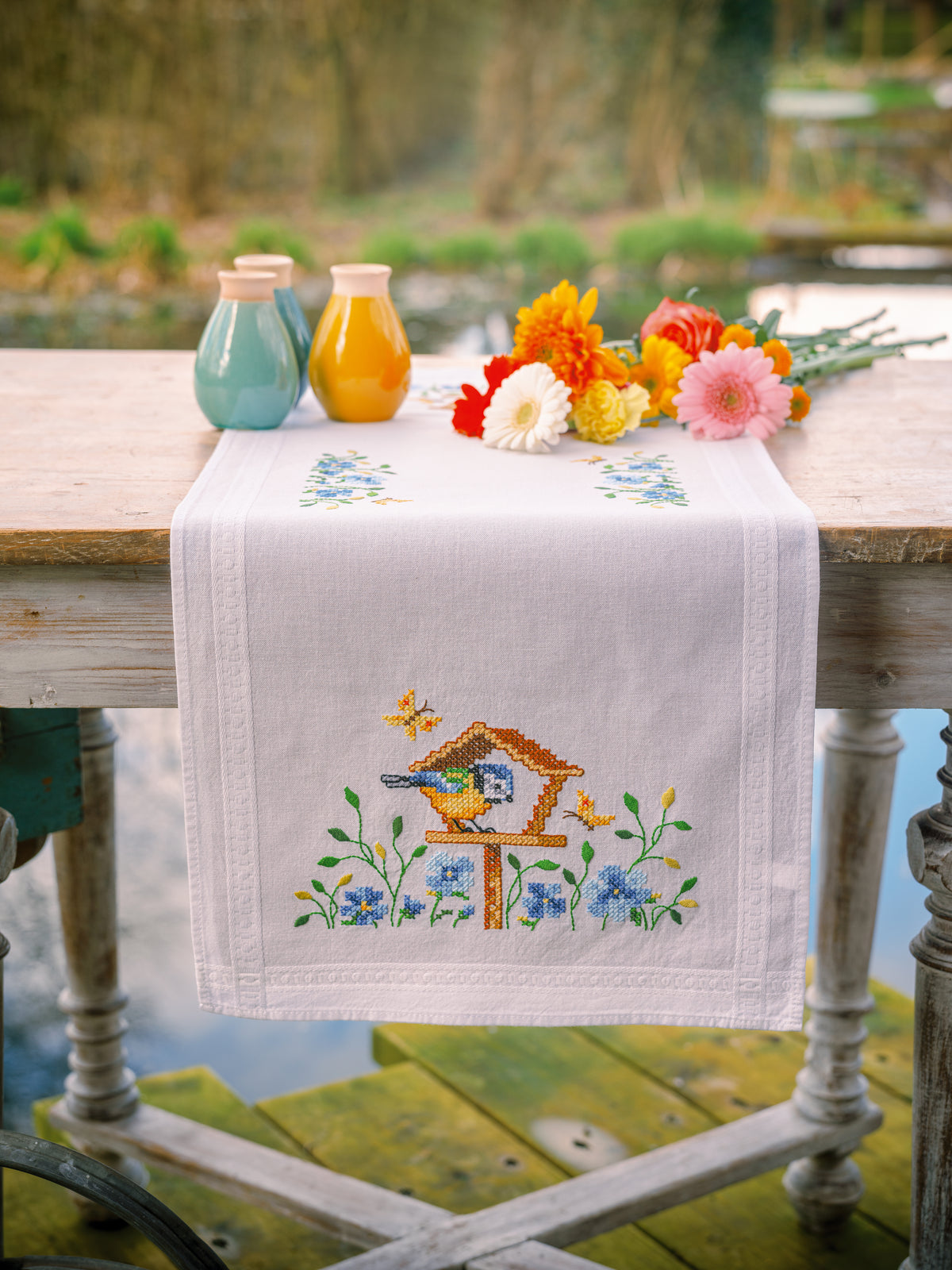 Embroidered table runner with birdhouses design