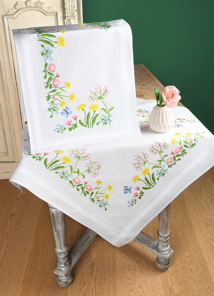 White table runner embroidered with colourful field flowers