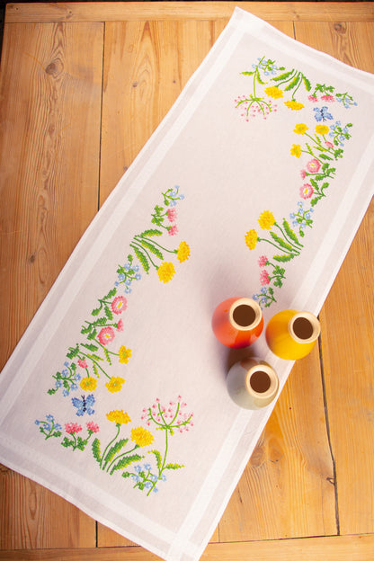 White table runner embroidered with colourful field flowers