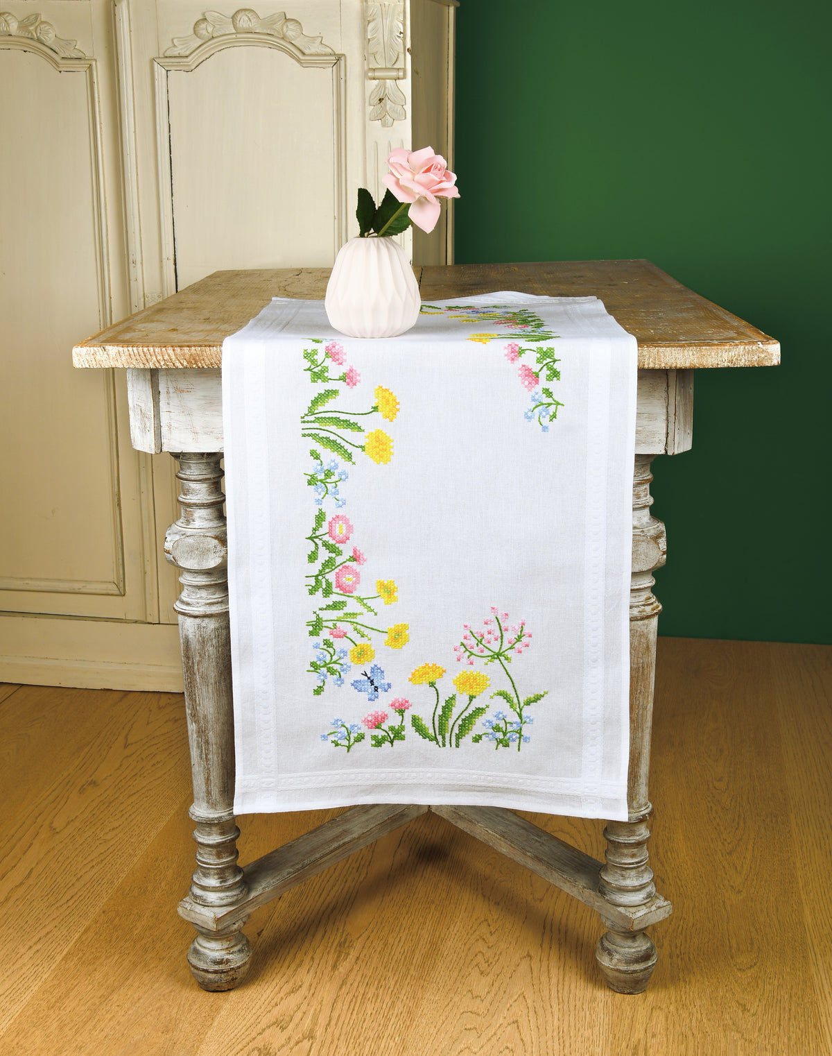 White table runner embroidered with colourful field flowers