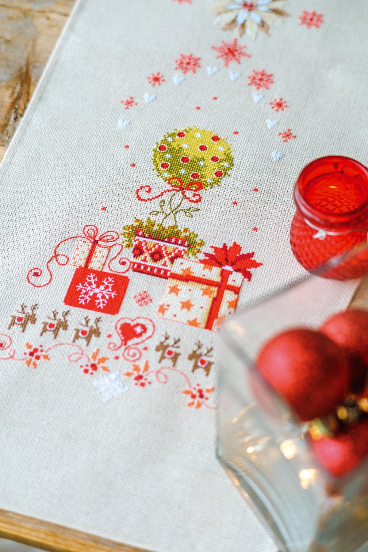 Christmas table runner with presents under a tree in cross stitch