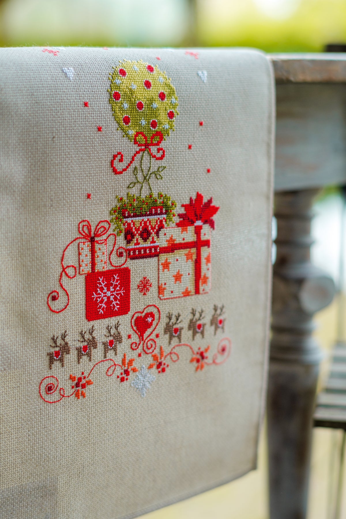 Christmas table runner with presents under a tree in cross stitch