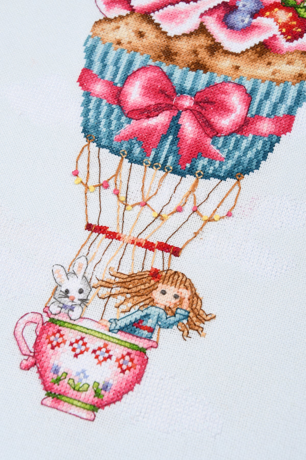 Cross stitched cupcake shaped like a hot air balloon