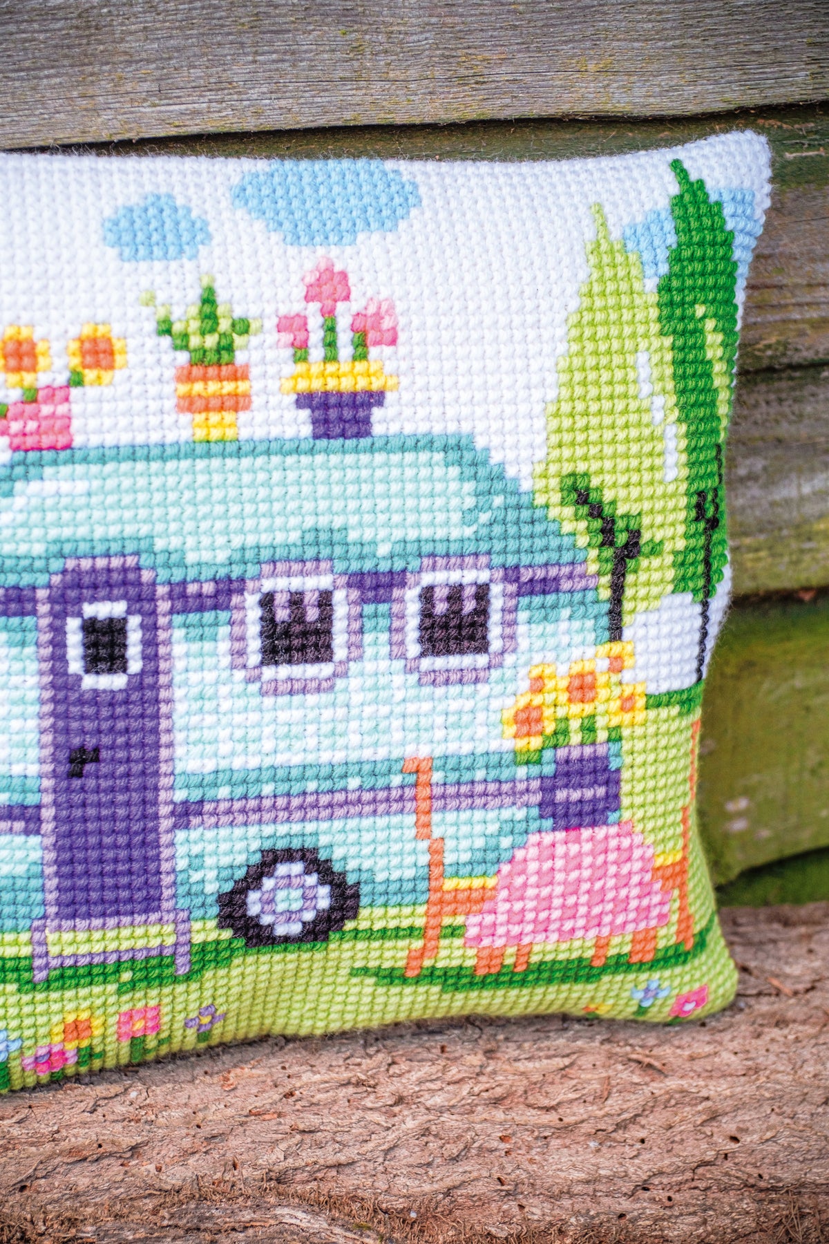 Cross stitch cushion with a road trip holiday design