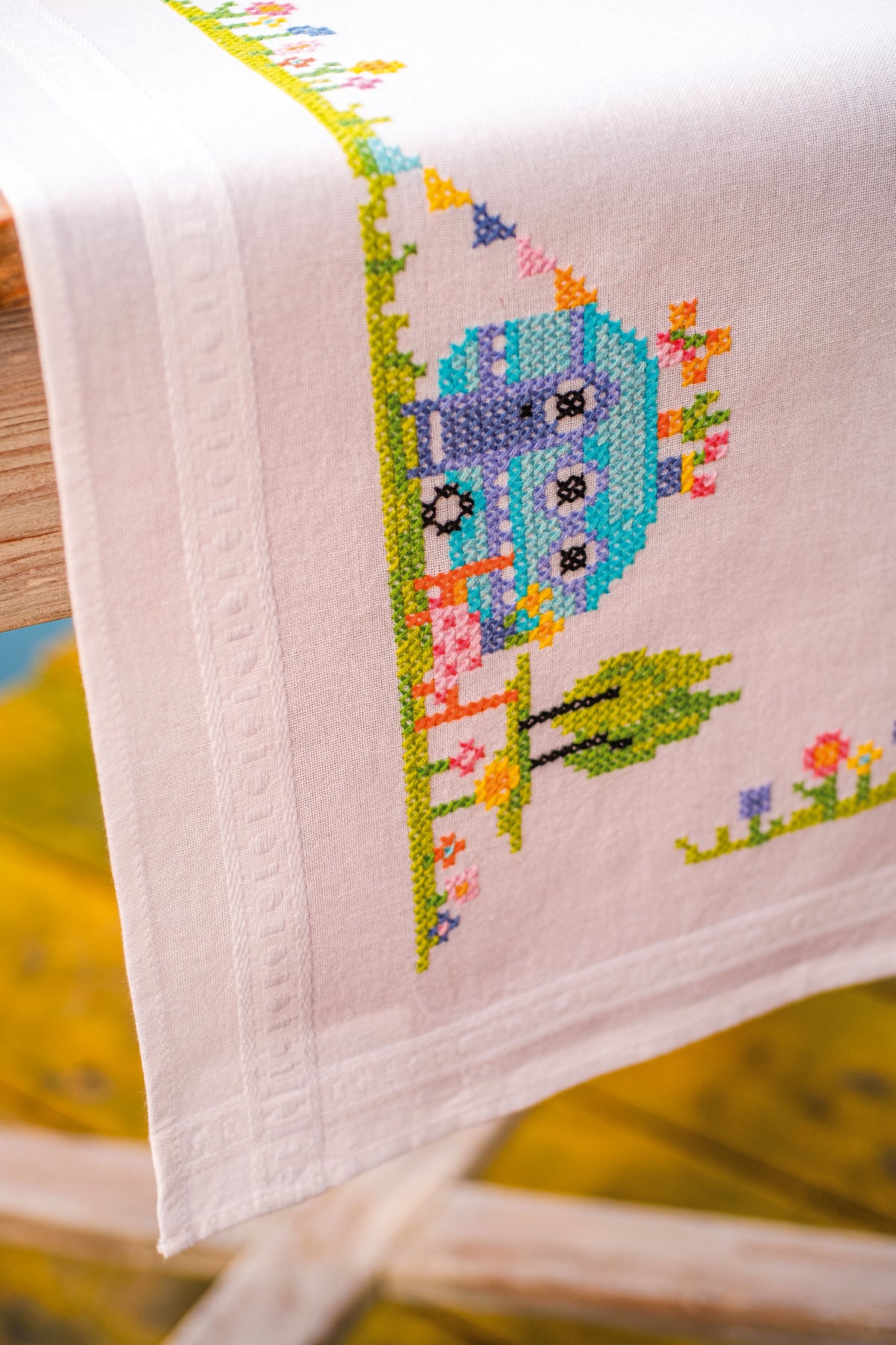 Cross stitch table runner with road trip holiday motifs