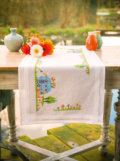 Cross stitch table runner with road trip holiday motifs