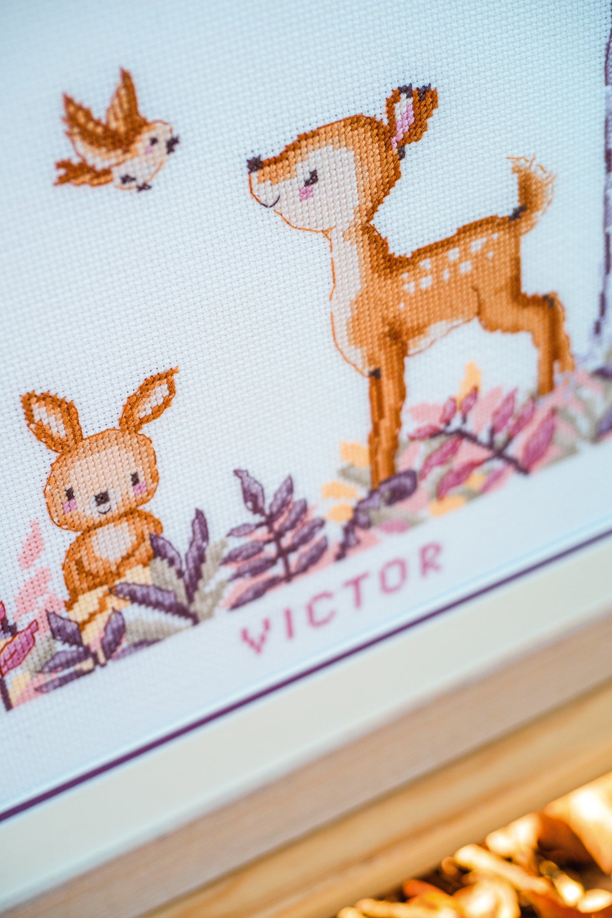 Cross stitch of woodland animals in a forest