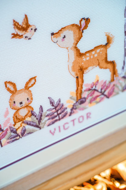 Cross stitch of woodland animals in a forest