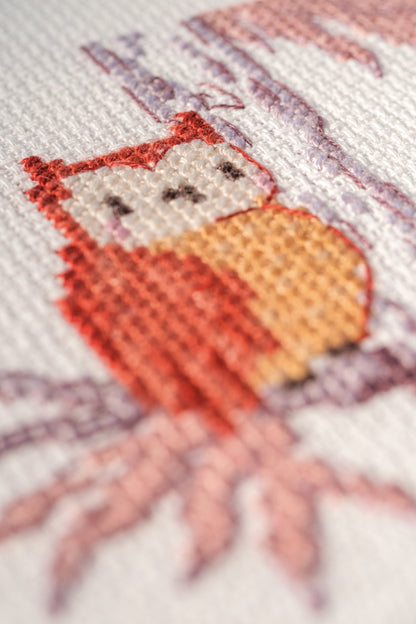 Cross stitch of woodland animals in a forest