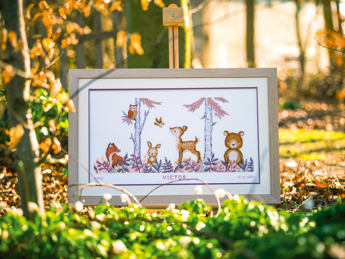 Cross stitch of woodland animals in a forest