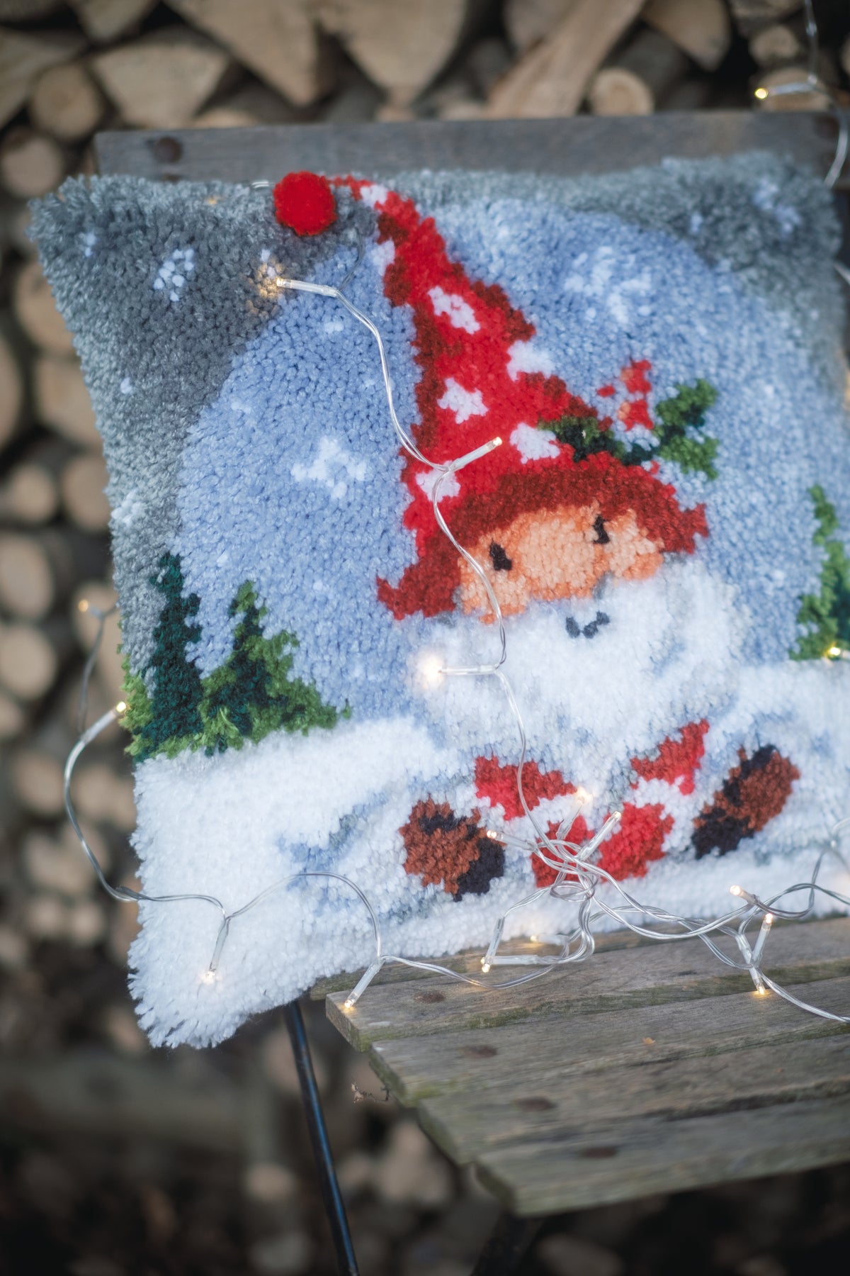 Latch hook cushion with a Christmas gnome in the snow