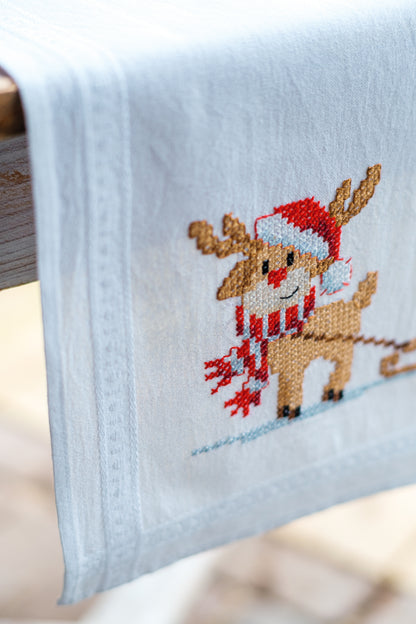 Embroidered table runner with gnome and reindeer motifs