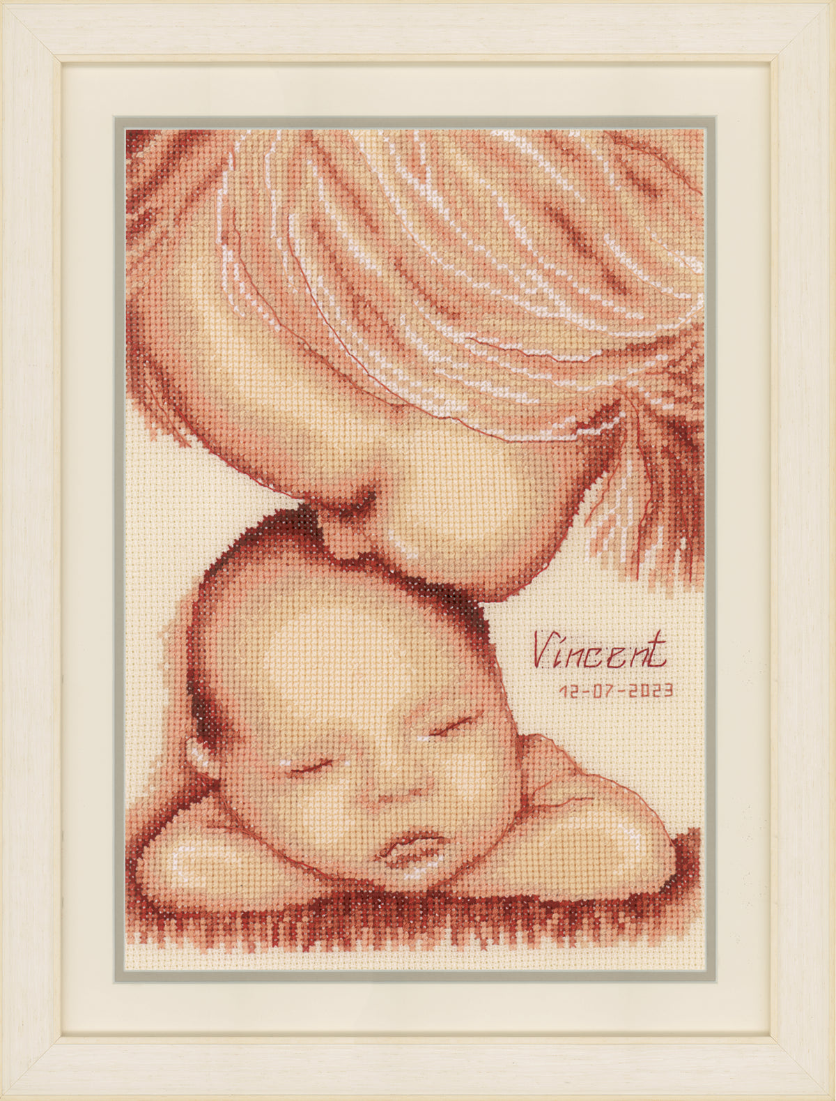 Cross stitch of two children with a heart